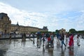 Famous Paris Louvre. People in main courtyard Cour Napoleon with Louvre Museum with Louvre Pyramid