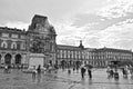 Famous Paris Louvre. People in main courtyard Cour Napoleon with Louvre Museum with Louvre Pyramid