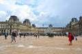 Famous Paris Louvre. People in main courtyard Cour Napoleon with Louvre Museum with Louvre Pyramid