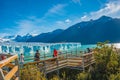 Famous Perito Moreno glacier and mountain turquoise lagoon with austral forests at golden Autumn in Patagonia, with tourists Royalty Free Stock Photo