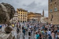 Florence ITALY - August 5, 2023 - Crowd in famous Piazza della Signoria with lion sculpture in perspective