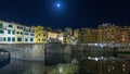 Famous Ponte Vecchio bridge timelapse hyperlapse over the Arno river in Florence, Italy, lit up at night Royalty Free Stock Photo