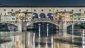 Famous Ponte Vecchio bridge timelapse over the Arno river in Florence, Italy, lit up at night Royalty Free Stock Photo