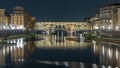 Famous Ponte Vecchio bridge timelapse over the Arno river in Florence, Italy, lit up at night Royalty Free Stock Photo