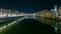 Famous Ponte Vecchio bridge timelapse over the Arno river in Florence, Italy, lit up at night Royalty Free Stock Photo