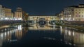 Famous Ponte Vecchio bridge timelapse over the Arno river in Florence, Italy, lit up at night Royalty Free Stock Photo