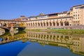 The famous Ponte Vecchio, the Old Bridge and city houses with reflections in the Arno River, Florence, Tuscany, Italy Royalty Free Stock Photo