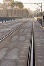 Famous portuguese bridge with railway tracks in perspective. Metro bridge in morning light in Porto, Portugal. Royalty Free Stock Photo