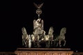 Quadriga statue on top of the Brandenburg Gate, Berlin Germany, illuminated at night.