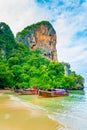 The famous Railay beach at Krabi, Thailand. Long tailed boats are prepared for passengers near limestone rock. Tropical paradise, Royalty Free Stock Photo