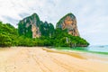 The famous Railay beach at Krabi, Thailand. Long tailed boats are prepared for passengers near limestone rock. Tropical paradise, Royalty Free Stock Photo