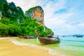 The famous Railay beach at Krabi, Thailand. Long tailed boats are prepared for passengers near limestone rock. Tropical paradise, Royalty Free Stock Photo