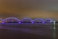 Famous railway bridge across Daugava river at night in Riga. Royalty Free Stock Photo