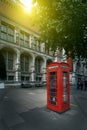 Famous red phone booth in London in the morning sun light. Movie poster concept. Toned Royalty Free Stock Photo