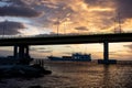 The famous Rio-Antirrio multi-suspension bridge Charilaos Trikoupis Bridge during the beautiful sunset with a ferry ship in the