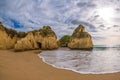 Famous rock formation with the cave on the beach of Tres Irmaos in Alvor, PortimÃÂ£o, Algarve, Portugal, Europe.