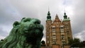 The famous Rosenborg castle in Central Copenhagen. Lion statue in focus in the foreground Denmark Royalty Free Stock Photo