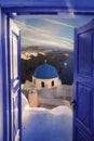 Santorini view with churches against blue door in Thira town, Greece Royalty Free Stock Photo