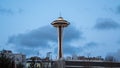 Famous Seattle Space Needle tower among residential buildings late in the evening