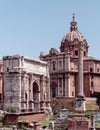 The famous Septimius Severus triumph arch in front of St. Luca and Martina church Domus at the Roman Forum. Royalty Free Stock Photo