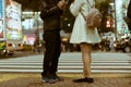 Dating couple standing by the Shibuya Crossing and exchanging phone numbers in Tokyo, Japan Royalty Free Stock Photo