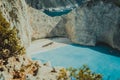 Famous shipwreck on Navagio beach with turquoise blue sea water surrounded by huge white cliffs. Famous landmark Royalty Free Stock Photo