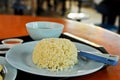 Famous Singaporean Hainanese Chicken rice with soup in a food court hawker center served in blue plate Royalty Free Stock Photo