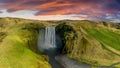 Famous Skogafoss waterfall with a rainbow. Dramatic Scenery of Iceland during sunset.