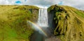 Famous Skogafoss waterfall with a rainbow. Dramatic Scenery of Iceland during sunset.