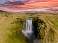 Famous Skogafoss waterfall with a rainbow. Dramatic Scenery of Iceland during sunset.