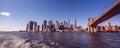 Famous Skyline of downtown New York City, Brooklin Bridge and Manhattan with skyscrapers illuminated over East River panorama. New Royalty Free Stock Photo