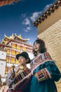 A pair of Tibetan mother and son look into the distance reverently Royalty Free Stock Photo