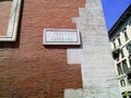 Piazza Venezia sign on brick wall, Rome, Italy.