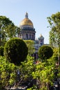 Famous St. Isaac Cathedral on summer day. Green trees and golden domes of cathedral on a sunny day. Saint Petersburg. Russia Royalty Free Stock Photo