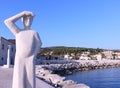 Famous stone monument of person looking into a horizon in a small town Postira Croatia, Brac island.