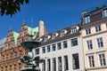 The famous Stork fountain and traditional old houses on the street in the center of Copenhagen. Royalty Free Stock Photo