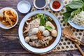 Thai style noodle soup served with vegetable flat lay on wood table