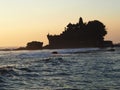 The famous temple Tanah Lot built on a built on a rocky island in the middle of the water at sunset in Bal, Indonesia