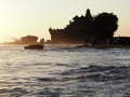The famous temple Tanah Lot built on a built on a rocky island in the middle of the water at sunset in Bal, Indonesia