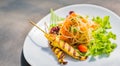 Famous Thai papaya salad or Somtum with Chicken satay on side