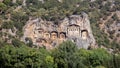 Famous tombs carved inside rocks in ancient Kaunos city, Turkey. Lycian Royal mountain tombs carved into the rocks near the town o Royalty Free Stock Photo
