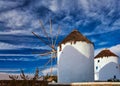 Famous tourist attraction of Mykonos, Greece. Two traditional historic whitewashed windmills. Summer, blue sky