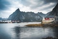 Famous tourist attraction of Reine in Lofoten, Norway with red rorbu houses, clouds, rainy day with bridge and grass and Royalty Free Stock Photo