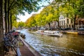 Famous tourist Canal Boats in the Herengracht Gentlemen`s Canal with its large historic houses in the city center of Amsterdam