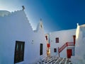 Famous tourist landmark, Mykonos island, Greece. Entrance to white Greek Orthodox church of Panagia Paraportiani Royalty Free Stock Photo