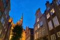 Famous touristic Mariacka street in Gdansk, Poland with view of St Mary's Church at dusk Royalty Free Stock Photo