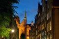 Famous touristic Mariacka street in Gdansk, Poland with view of St Mary's Church at dusk Royalty Free Stock Photo