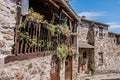Perspective of facades of typical schist houses with wooden balcony and several flowers in pots, Casal de SÃÂ£o SimÃÂ£o PORTUGAL