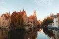 famous traditional ancient buildings and tower reflected in canal, bruges, belgium
