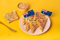 The famous traditional Australian food Fairy Bread on a yellow background.